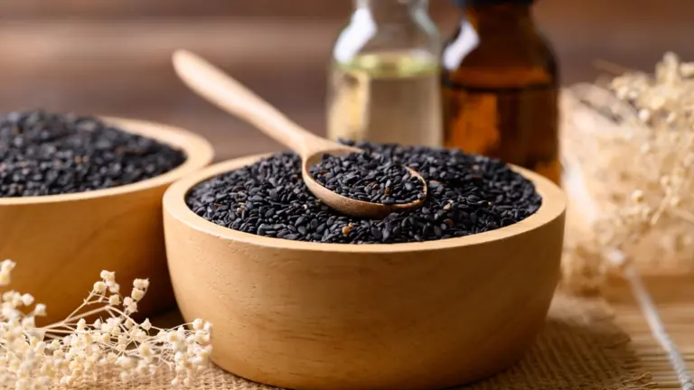 Black cumin seeds with oil on a table