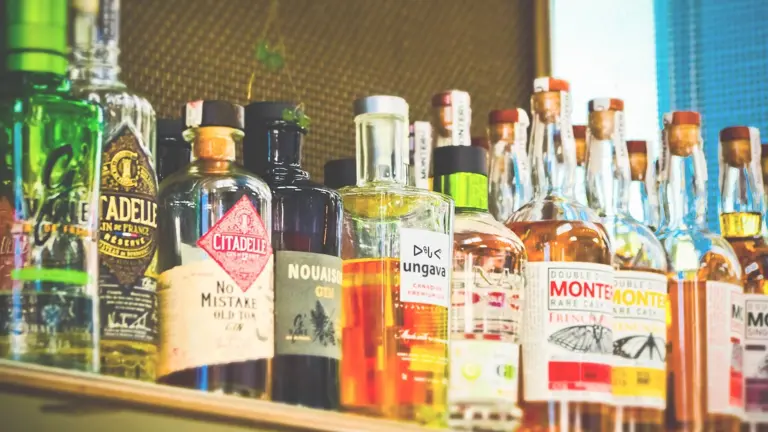 Alcohol bottles lined up on a shelf