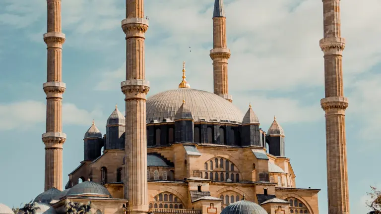 Mosque with domes and minarets under a blue sky