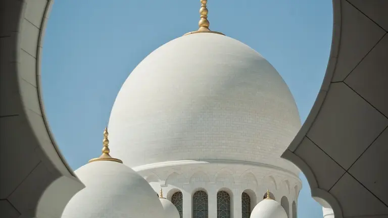 Mosque dome seen through an arch