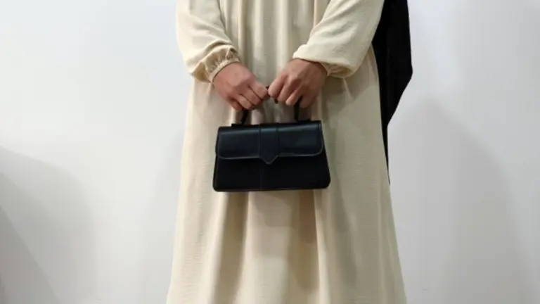 Muslim woman wearing a beige abaya and black khimar