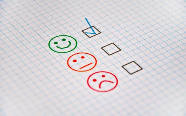 Exam sheet with checkboxes and evaluation faces