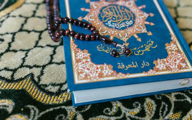 Quran with prayer beads illustrating Quran recitation styles