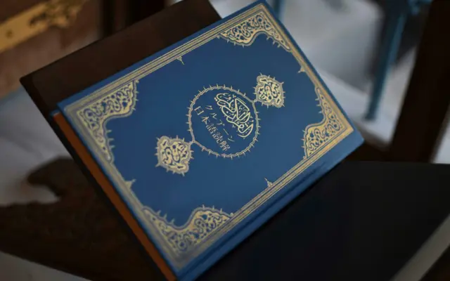 Blue Quran placed on a reading stand