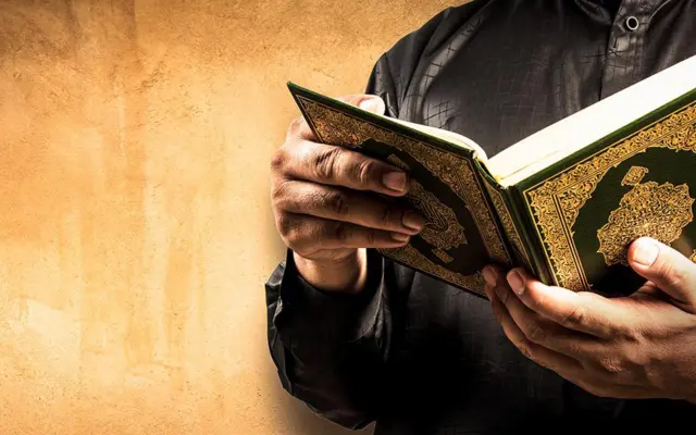 Pilgrim reciting the Quran in Arabic during Umrah to strengthen barakah and spiritual connection with Allah
