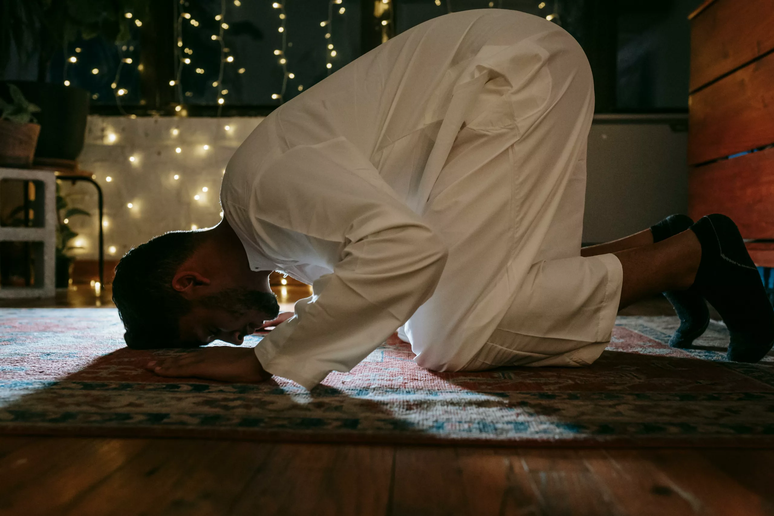 Man prostrating during the night prayer