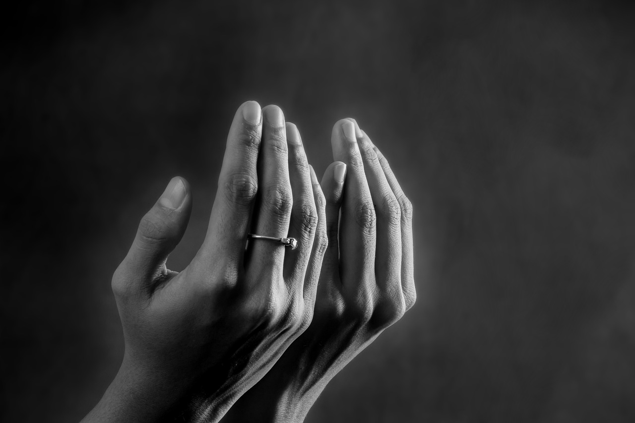 Hands raised in supplication for Istikhara prayer