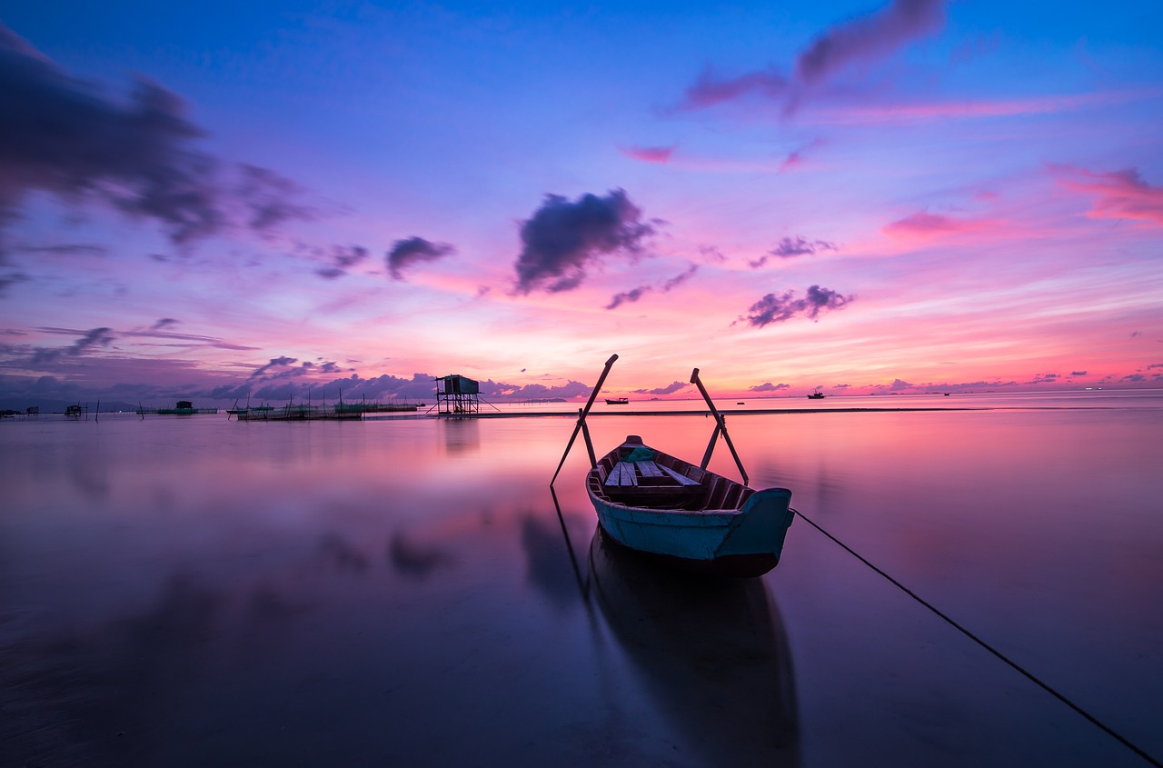 Boat on calm water at sunrise